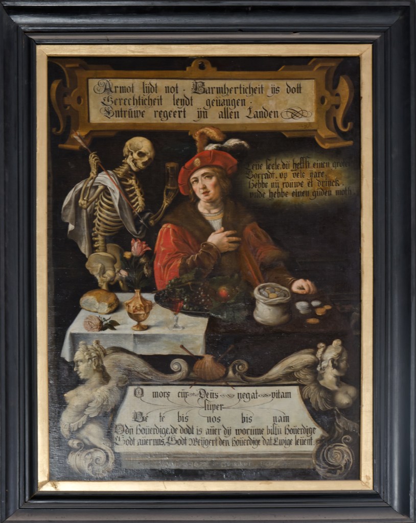 A skeleton stands beyond a seated man in fine clothes with food and coins before him.