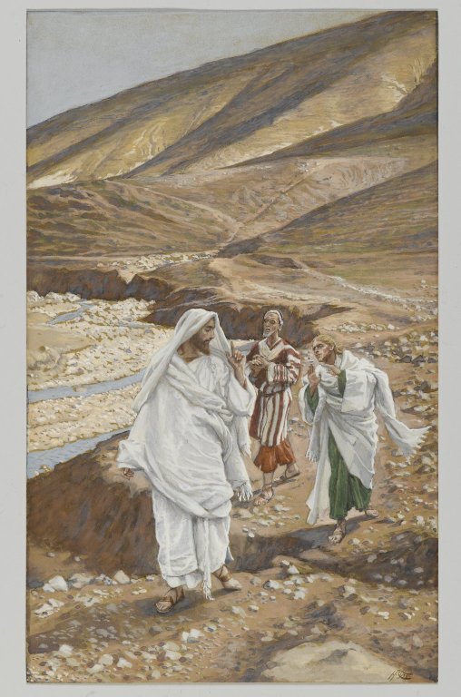 Three figures wearing Biblical clothing standing in a sandy landscape. Two of them follow the first, who is turning to speak to them.